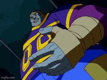 a cartoon character in a purple and yellow outfit is standing in a dark room with his arms outstretched .