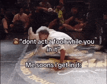 a man is doing a trick in front of a crowd and says " dont act a fool while you in it