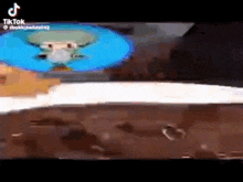squidward from spongebob squarepants is standing next to a piece of chocolate on a table .