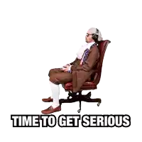 a man wearing headphones sits in an office chair with the words time to get serious above him
