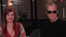 a man and a woman wearing sunglasses are smiling