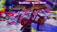 a man in a purple suit is standing in front of a sign that says sonic racing
