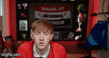 a man in front of a sign that says " made in drama "