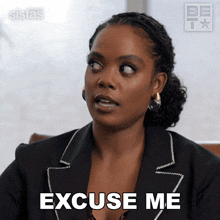 a woman says excuse me while wearing a black jacket and earrings