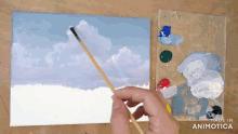 a person is painting a cloudy sky on a canvas with the words made in animotica below them