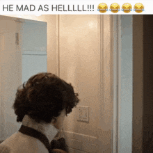 a man standing in front of a door with a caption that says he mad as hell