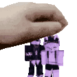 a hand is holding a purple toy robot on top of another toy robot .