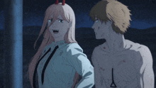 a man and a woman are standing next to each other and the woman has horns