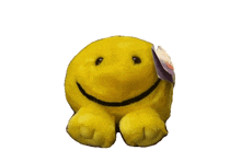 a stuffed smiley face with a tag on it