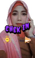 a woman wearing a pink hijab and a check in sticker