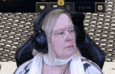 a woman wearing headphones sitting in a chair