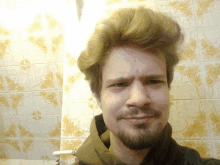 a man with a beard is looking at the camera