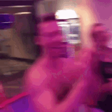 a blurry picture of a person 's face with a purple background