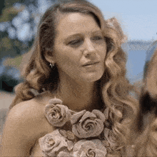 a woman in a dress with roses on it