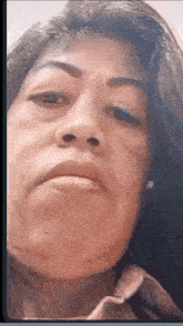 a close up of a woman 's face with a serious expression .