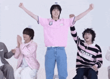 a man wearing a pink shirt that says frankie on the front