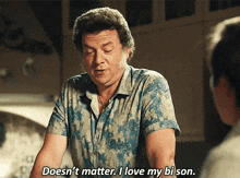 a man in a blue shirt is saying " doesn 't matter i love my bi son "