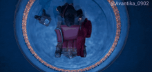 a man sits on a throne in a dark room with the hashtag avantika_0902