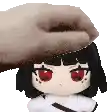 a person is petting a stuffed animal with red eyes on its head .