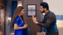 a man and a woman are having an argument in a room .