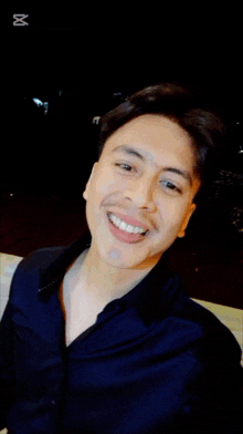 a man is smiling in front of a screen that says ' capcut ' on it