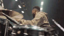 a man playing drums in a dark room