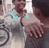 a man is hugging another man in front of a motorcycle in a street .