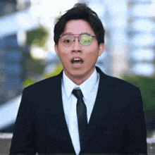 a man in a suit and tie is making a funny face
