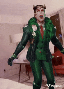 a man in a green suit with horns is standing in a room with a viggle.ai watermark