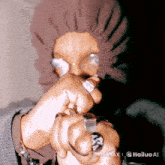 a person wearing a hood and glasses has a ring on their finger with the letters aa on it