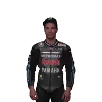 a man wearing a petronas sprinta yamaha jacket stands with his hands in his pockets