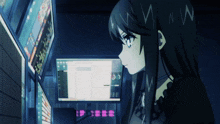 a girl is looking at a computer screen with the letters n and w on her head