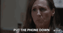 a woman with her eyes closed says put the phone down on netflix