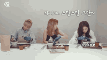 three women sitting at a table with a sign that says twice on it