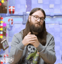 a man with long hair and a beard is wearing a clash royale sweater
