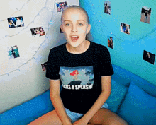 a girl is wearing a black shirt that says make a splash