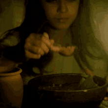 a close up of a girl with her eyes closed eating something