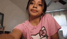 a girl in a pink shirt with a cat on it