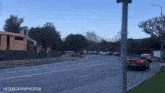 a few cars are driving down a street with a sign that says ietq0cfirephotos