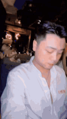 a man wearing a white shirt with a red lettering that says " i love you "