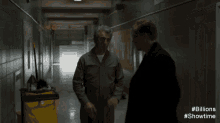 a man is cleaning the floor in a hallway with the hashtag # billions showtime on the bottom