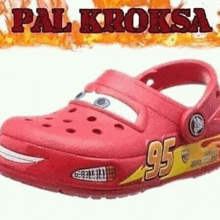 a pair of red crocs that look like cars lightning mcqueen .