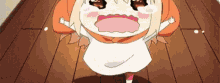 a little girl is standing on a wooden floor with her mouth open and crying .