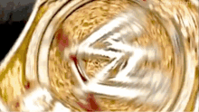 a close up of a gold object with a swirling pattern