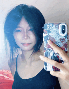 a woman taking a selfie with a phone case that says ' i love you ' on it