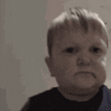 a baby is making a funny face with his mouth open .