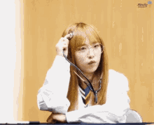 a girl wearing glasses and a stethoscope has the word mucha on the bottom right