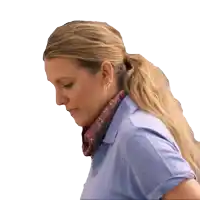 a woman wearing a scarf around her neck looks down