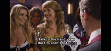 a group of women are talking to a man holding a soccer ball with the words talk to the hand