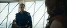 a man in a superhero costume is standing in front of a large window
